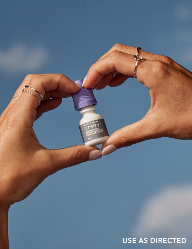 Pair of hands holding a box of Lumify redness relieving eye drops